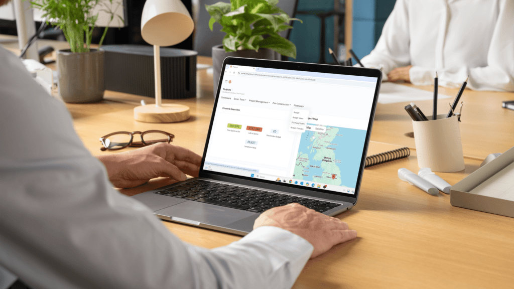 Smartstruct dashboard on a laptop showing map and metrics